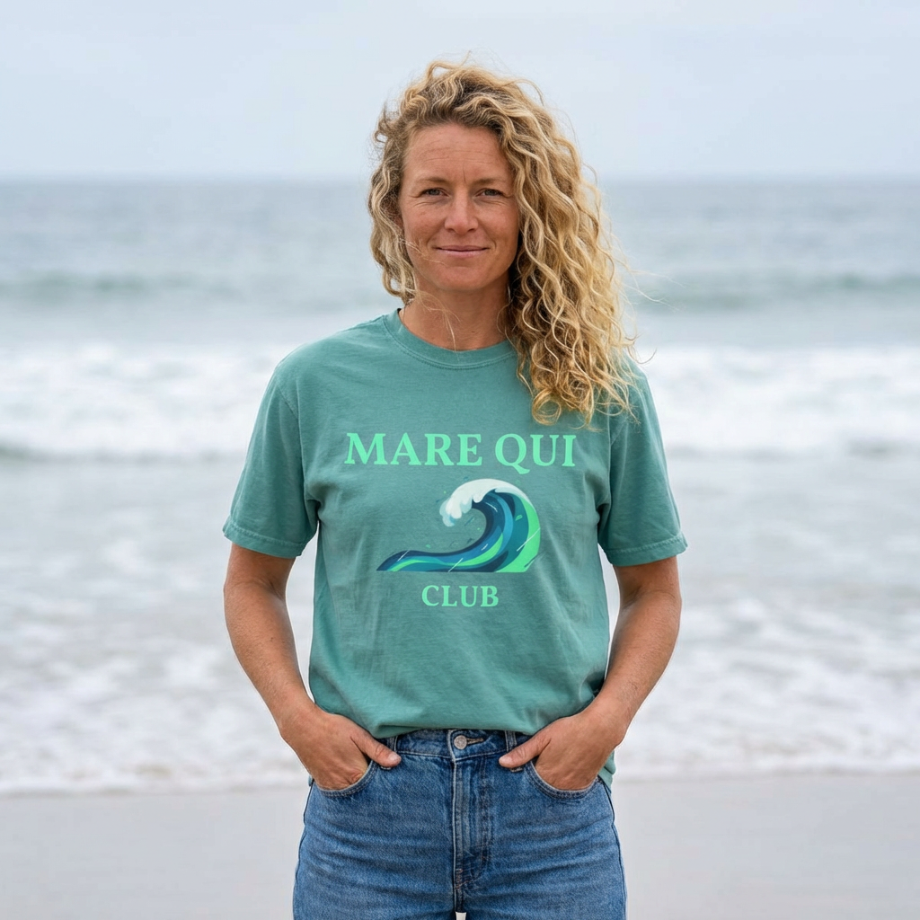 woman wearing Mare Qui Club ocean wave graphic t-shirt by the ocean