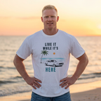 man wearing live it while its here t-shirt by the sea Mare Qui Club