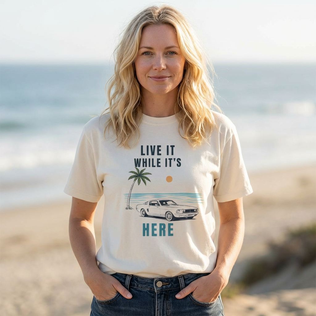 Woman wearing live it while its here t-shirt by the sea Mare Qui Club