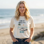 Woman wearing live it while its here t-shirt by the sea Mare Qui Club